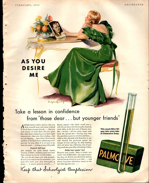 Vintage 1933 Palmolive ad showing a woman in a green dress holding a photo, promoting youthful skin with olive oil soap.