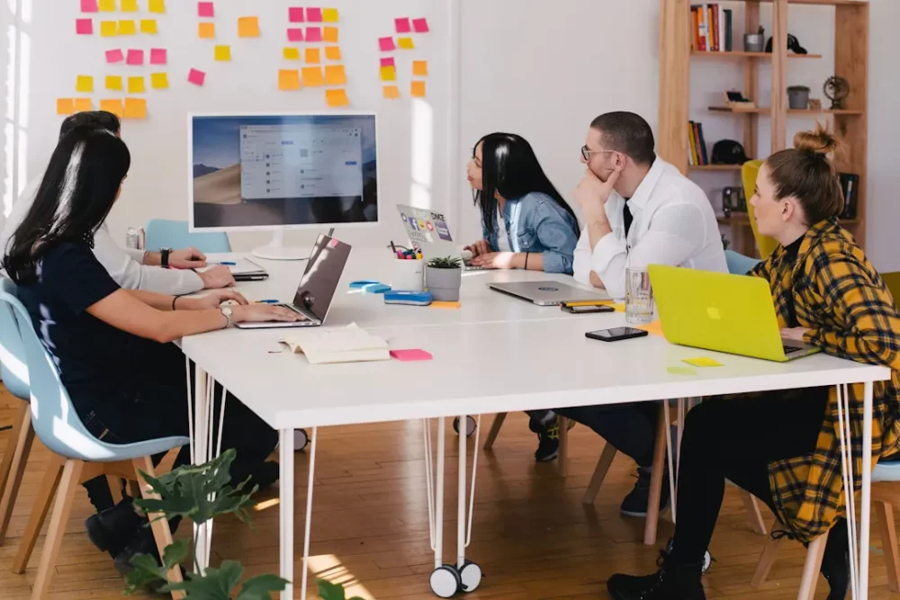 A team in an office discussing RFP automation tools during a meeting